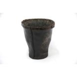 An antique leather shot bucket