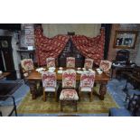 A substantial solid oak refectory style dining table and set of eight dining chairs by 'Royal Oak Fu