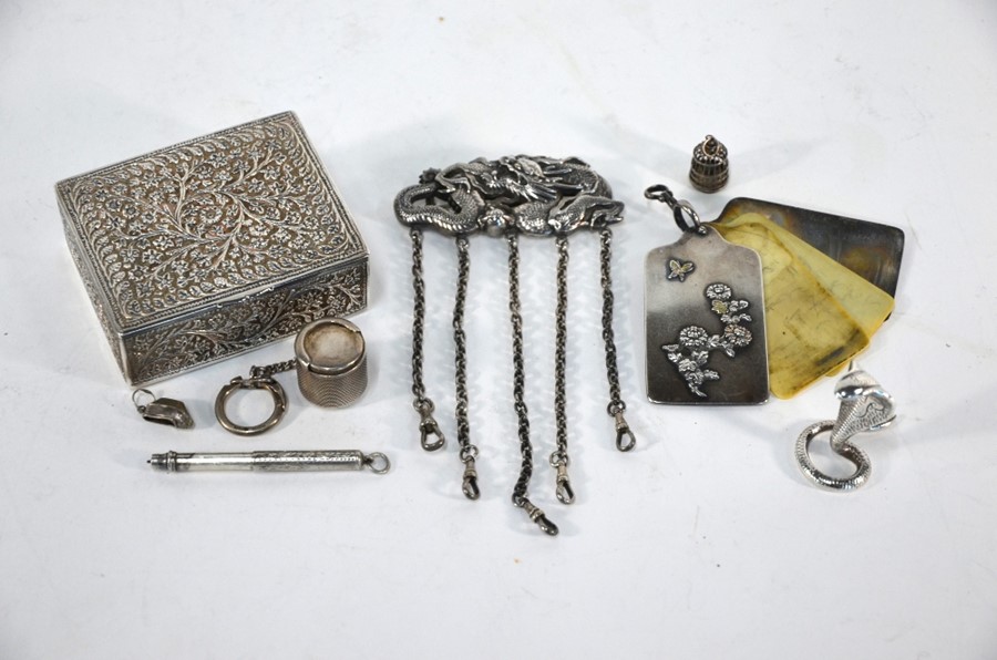 A Chinese white metal chatelaine with finely-worked dragon-and-pearl brooch