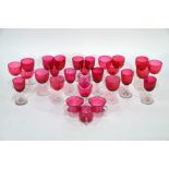 Twenty-five antique cranberry wine glasses to/w three custard cups