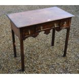 A Georgian oak three drawer lowboy