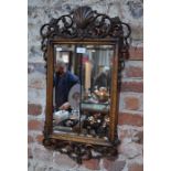A good quality Edwardian carved oak wall mirror with bevelled plate