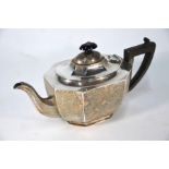 A silver teapot of elongated hexagonal form