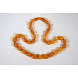 A graduated amber oval bead necklace