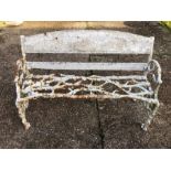 A Victorian cast iron garden bench of naturalistic design, heavily weathered, 130 cm long