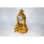 An antique gilt spelter 8-day portico mantle clock
