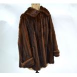 A brown mink fur short coat with shawl collar and turned cuff sleeves