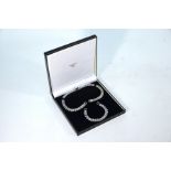 A contemporary white metal gatelink necklace and bracelet set