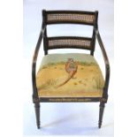 A Regency ebonised and gilt decorated cane panelled open armchair (2 in lot)