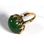An oval green hardstone ring