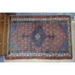 An antique Persian Afshar rug with centre medallion design