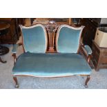 An Edwardian carved mahogany two seater salon settee