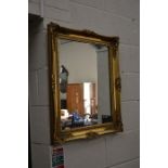 A rectangular wall mirror in decorative gilt framed wall mirror