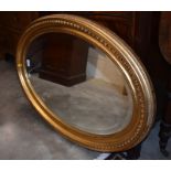 A bevelled oval wall mirror