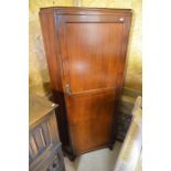 A mahogany floor standing corner cupboard