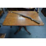 George III mahogany rectangular tilt top breakfast table to/w an old air rifle (2)