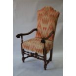 An antique walnut framed open armchair