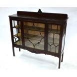 A red walnut astragal-glazed display cabinet in the Chippendale Revival style