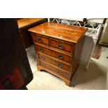 A small reproduction yew wood crossbanded chest of drawers