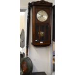 A 1930s oak cased wall clock