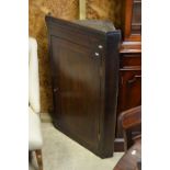 A 19th century oak hanging corner cupboard