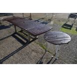 A large extending teak garden table by Lister to/with a circular teak top table (2)