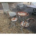A weathered metal three piece garden table/chair set and lounger (4)