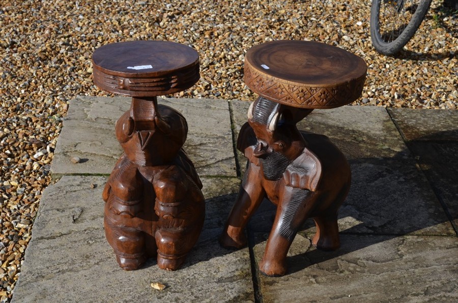 Two carved hardwood 'elephant' stools with circular seats