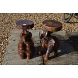 Two carved hardwood 'elephant' stools with circular seats