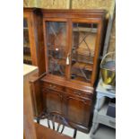 A reproduction mahogany bookcase cabinet