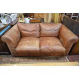A 'Burgess' two seater scroll arm sofa with brandy tan leather upholstery