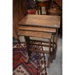 A nest of three rectangular-top oak tables