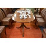 A Regency style mahogany and brass inlaid extending dining table