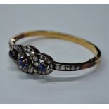 A diamond and blue sapphire bangle