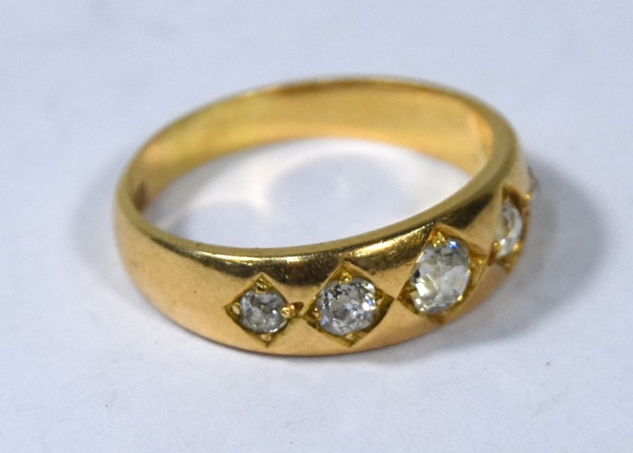 A five stone diamond gypsy ring