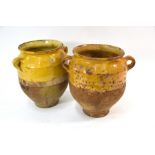 Two 19th century French terracotta olive jars with yellow glaze