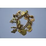 A 9ct yellow gold curb link bracelet with charms