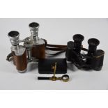 A 19th century laquered brass folding pocket microscope and two pairs of binoculars