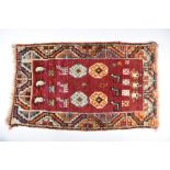 A Persian Gabbeh small red ground rug