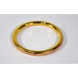 A 9ct yellow gold upper arm hollow bangle