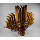 An antique Indian carved and painted wood Garuda head