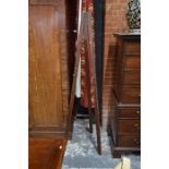 An antique stained pine folding easel