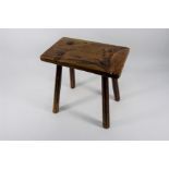 An antique rustic elm dairy stool