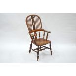 An antique elm seat hoop and stick back elbow chair