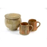 Two studio pottery glazed stoneware mugs with slab-sides and a jar