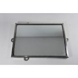 A plain and serviceable aluminium-framed wall mirror