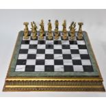 A modern inlaid marble and giltwood chess board
