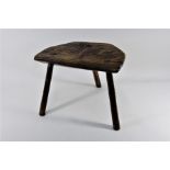 An antique rustic elm dairy stool