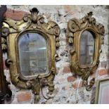 A near pair of antique mirror backed giltwood framed wall sconces