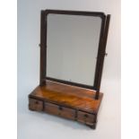 A 19th century mahogany toilet mirror on three drawer platform base